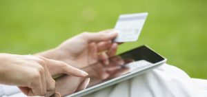 Person making payment using a credit card via tablet