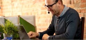 Person using a laptop with a headset