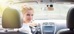 Female driving car and looking back